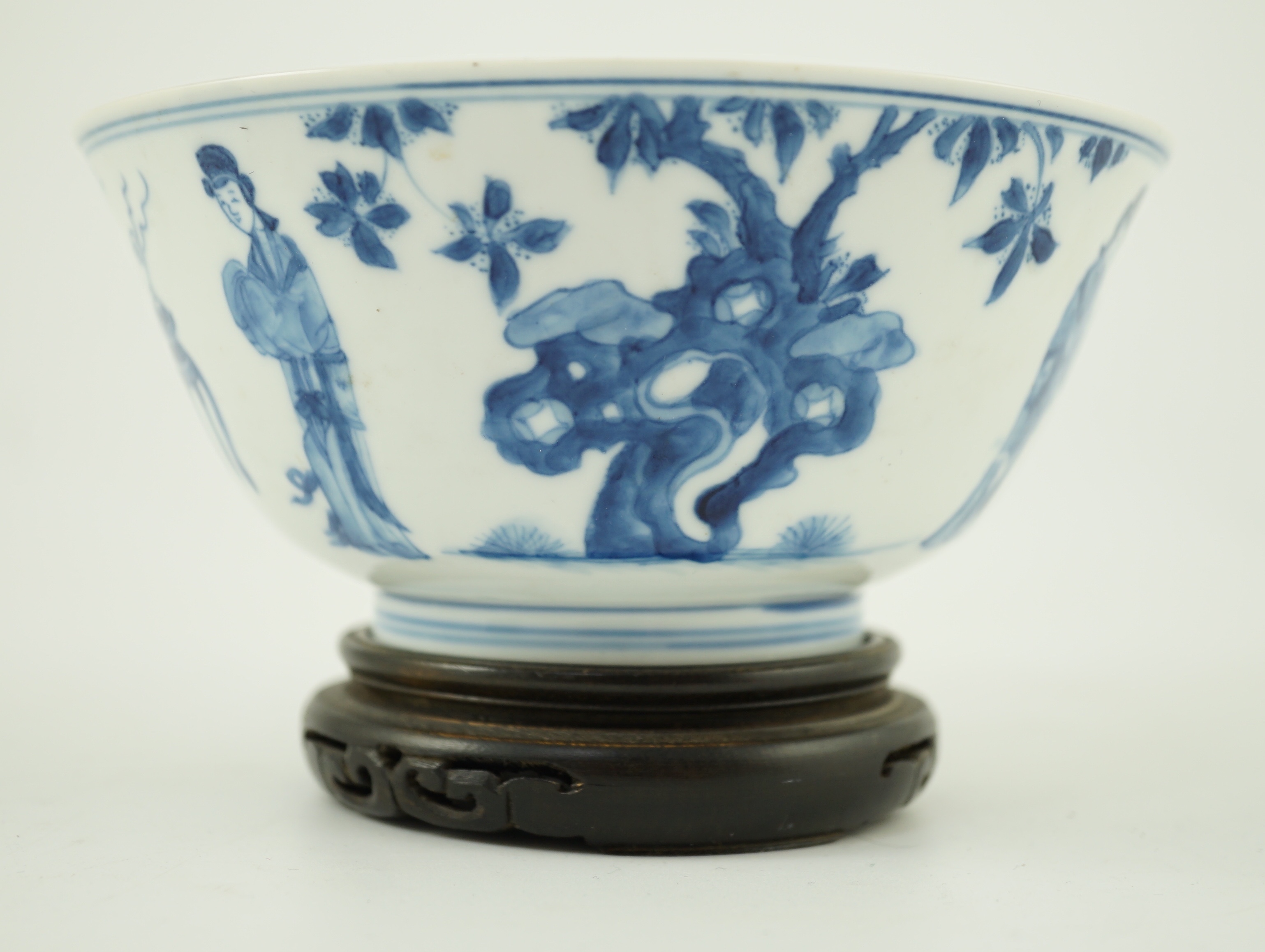 A Chinese blue and white ‘ladies’ bowl, Kangxi period, 15.5cm diameter, wood stand